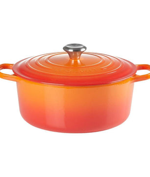 Der Le Creuset Signature Bräter in Orange aus Gusseisen mit silbernem Knauf und praktischen Griffen ist von der Marke Le Creuset abgebildet vor weißem Hintergrund.