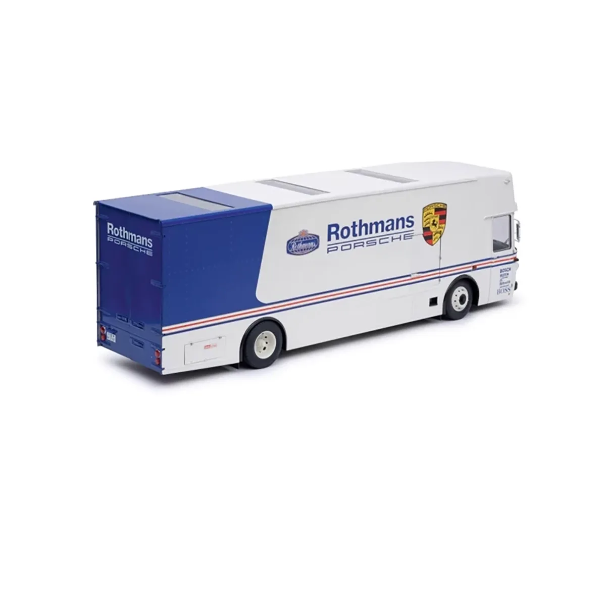 Schuco Mercedes-Benz O 317 Sammlermodell 1:18 in weiß, mit Renntransporter-Design und blauen Rothmans Porsche Racing-Decals, von hinten betrachtet.