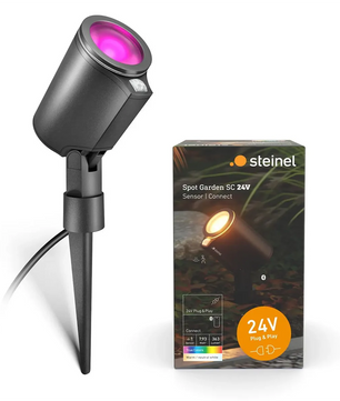 Der STEINEL Spot Garden 24V LED-Bodenstrahler in Schwarz, der hier neben seiner Verpackung mit einem leuchtend violetten Schein abgebildet ist, verfügt über die fortschrittliche LED-Gartenstrahler-Technologie von Steinel. Dieser moderne Gartenstrahler vereint elegantes Design und innovative Leistung und ist damit die ideale Wahl für die Beleuchtung Ihrer Außenbereiche.