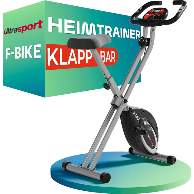 Hier ist der überarbeitete Satz unter Verwendung Ihrer Produktdaten: Der Ultrasport F-Bike Heimtrainer – schwarz, ein klappbarer Heimtrainer mit digitalem Display, wird vor seiner farbenfrohen Produktverpackung gezeigt – dieser platzsparende klappbare Heimtrainer von Ultrasport bietet eine effiziente Lösung für Ihr tägliches Fitnesstraining zu Hause.