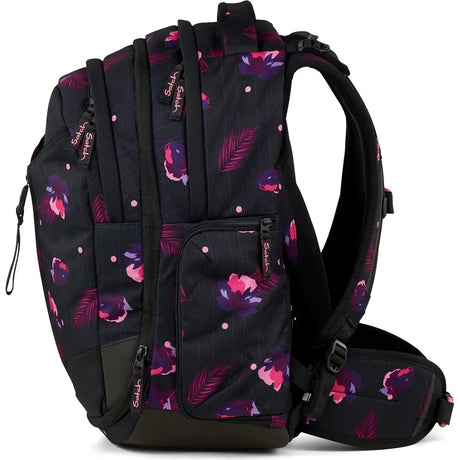Ergonomisch und erweiterbar: Der Satch Match Schulrucksack - Mystic Nights von Satch bietet mehrere Taschen, gepolsterte Schultergurte und ein florales Design in Schwarz mit pink-lilanen Blumen- und Blattmustern für hohen Tragekomfort.