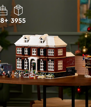 Das LEGO Ideas Home Alone, Haus der McCallisters von LEGO zeigt detailreich das kultige Filmhaus mit Minifiguren und Van, ideal für Erwachsene und liebevoll auf einem Holztisch präsentiert.