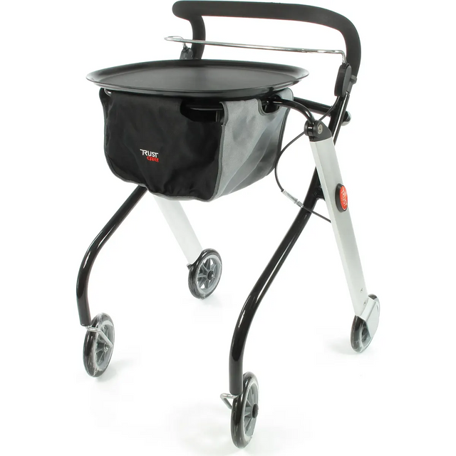 Der Trust Care Let's Go Rollator - schwarz von Trust Care ist ein schwarz-silberner, vierrädriger Rollator mit gepolstertem Griff und Fronttasche - die ideale kompakte Gehhilfe für den Innenbereich.