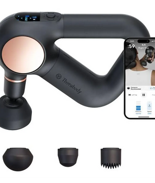 Das Therabody Theragun Sense Massagegerät – schwarz wird mit vier aufsteckbaren Aufsätzen geliefert und ist rechts neben einem Smartphone abgebildet, auf dessen Display die App-Steuerung zu sehen ist. Es bietet eine fortschrittliche Perkussionsmassage zur gezielten Linderung.