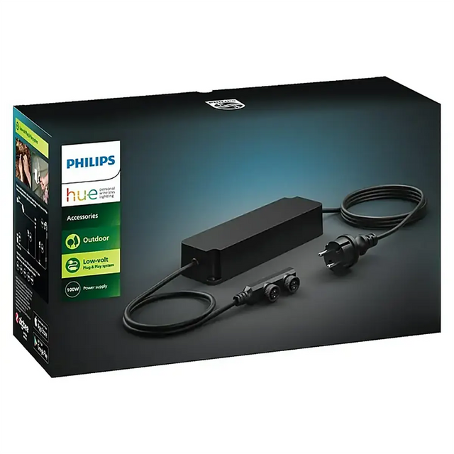 Philips Hue Outdoor-Netzteil 100 W – schwarz, verpackt in einer Box mit einem Bild des eleganten schwarzen Adapters und Steckers – ideal für Ihre smarte Außenbeleuchtung. Dieses Netzteil von Philips ist die perfekte Ergänzung für jedes Niedervolt-System und versorgt Ihre Außenbeleuchtung sicher und effizient mit Strom.