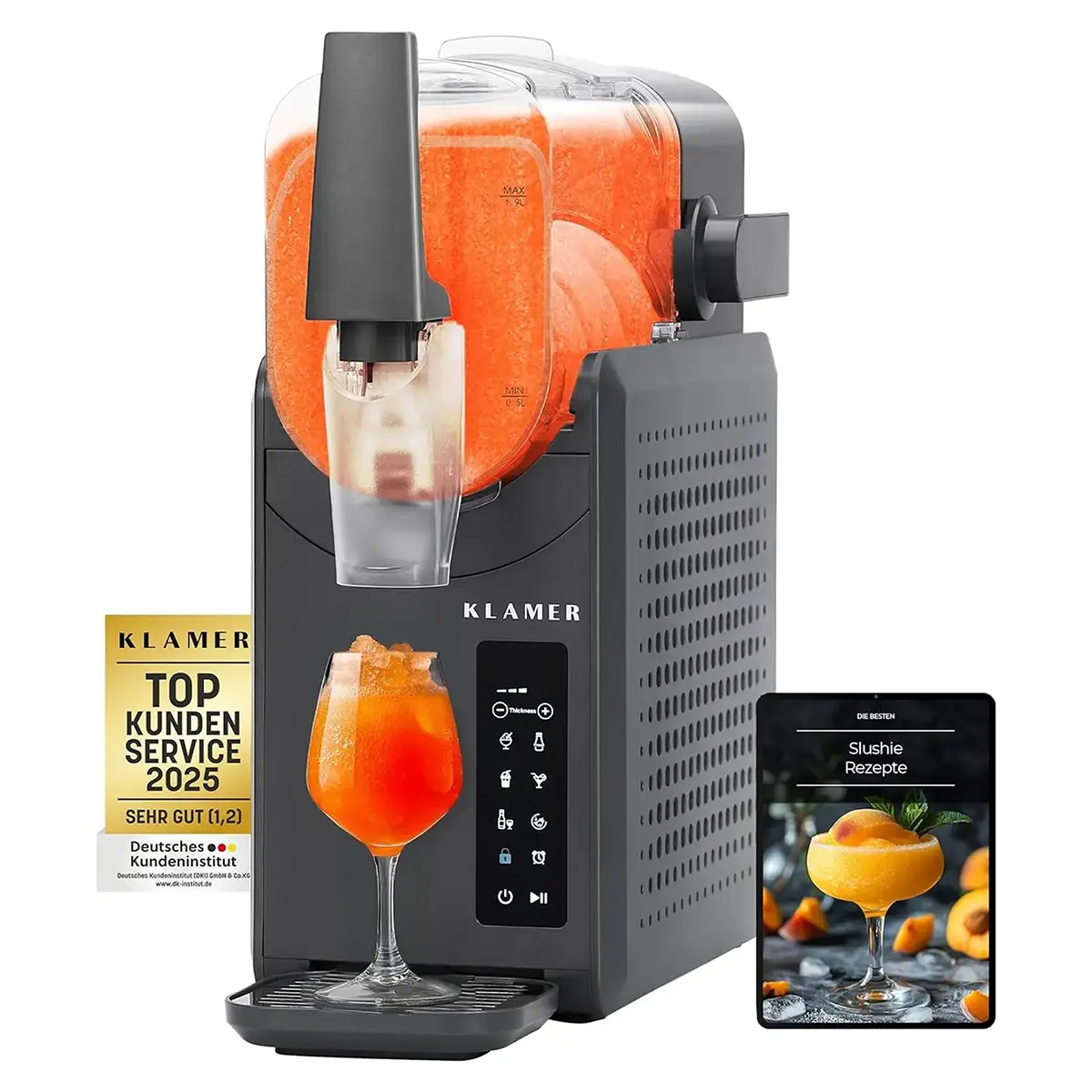 Die KLAMER Slush-Maschine mit 2,6 l – grau von KLAMER, die orangefarbenen Slush in ein Glas füllt, daneben liegen ein Rezeptbuch und eine Auszeichnungsplakette.