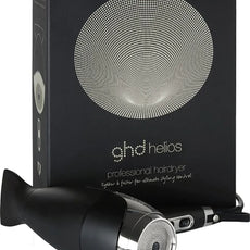 Der ghd helios Haartrockner - Schwarz von ghd steht vor seiner Verpackung mit modernem Runddesign und Branding. Mit innovativer Ionen-Technologie für geschmeidiges, glänzendes Haarstyling.