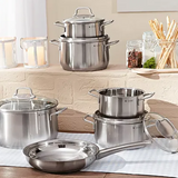 Das 6-teilige WMF Brillant Kochgeschirr-Set aus Edelstahl mit Glasdeckeln steht auf Tisch und Arbeitsplatte - spülmaschinengeeignet, induktionsgeeignet und ideal für moderne Küchen.